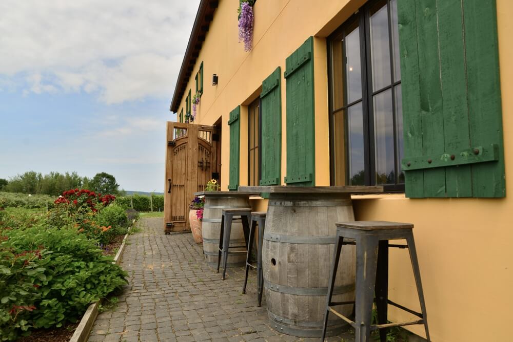 Bent Ridge Winery Bistro patio with green shutters and wine barrel tables near Windsor Nova Scotia