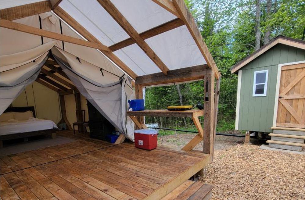 Birch Tent surrounded by trees at forest glamping retreat in Nova Scotia