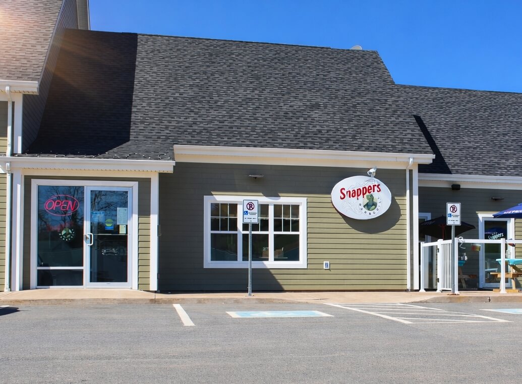 Exterior of Snappers Bar &amp; Grill restaurant in Kennetcook Nova Scotia with patio seating.